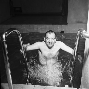A vivacious Senator Joe McCarthy emerges from a large vat of brine, part of his daily anti-Communist workout. Go, America, go!