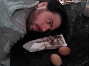 The author, posed with the ancient culinary arms of his House. Also posed with two eggs.